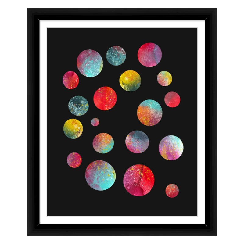 Framed artwork of circles with galaxy pattern on black background. 