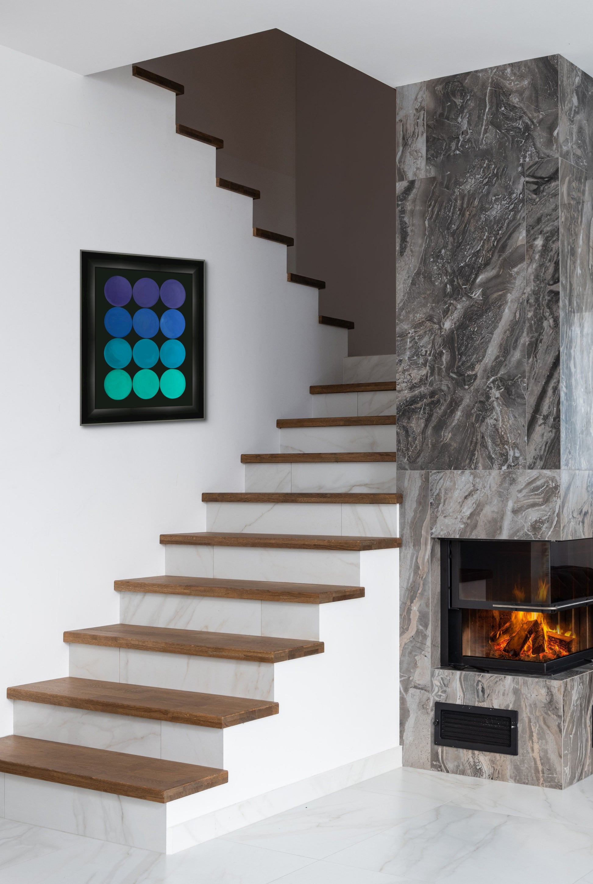 Modern staircase with wooden steps and a fireplace with stylish artwork. 